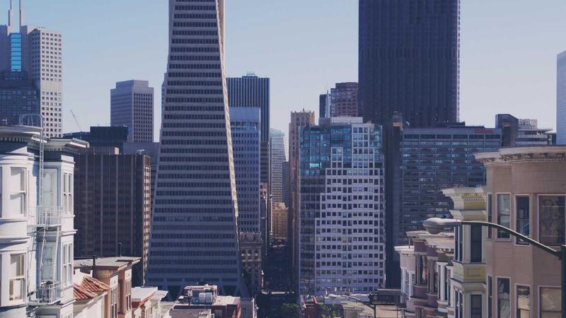 A sleek, modern lithium car jump starter placed securely under the hood of a car, with glowing LED indicator lights showing it is ready to boost the battery.