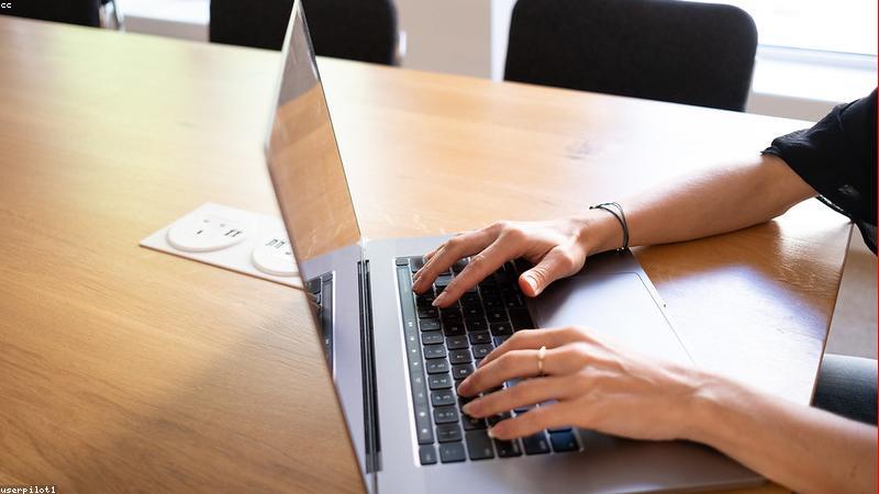 business professional typing on ultra-thin modern 2026 laptop in a bright stylish coworking space