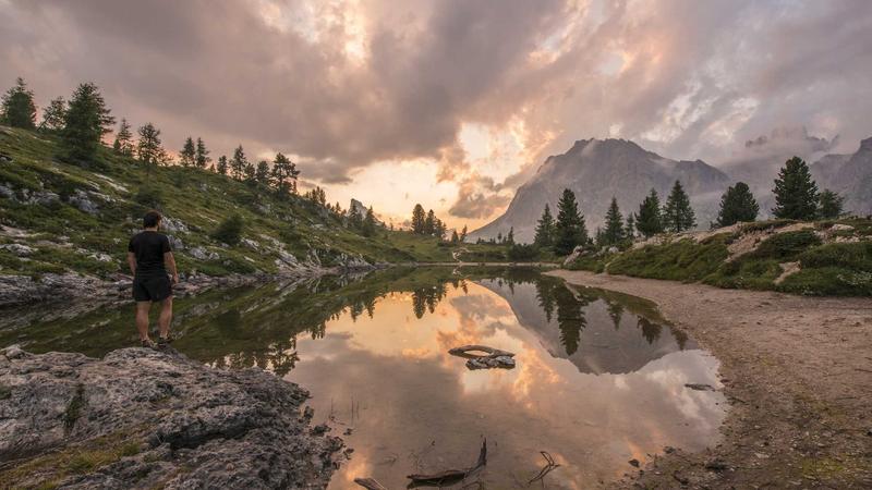 A sleek, futuristic laptop sitting on a wooden desk with a neon-lit city skyline visible through the window, highly detailed, photorealistic.