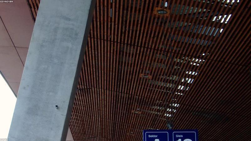 A sleek, modern smart home security hub featuring a biometric fingerprint scanner and facial recognition camera, set against a futuristic front door