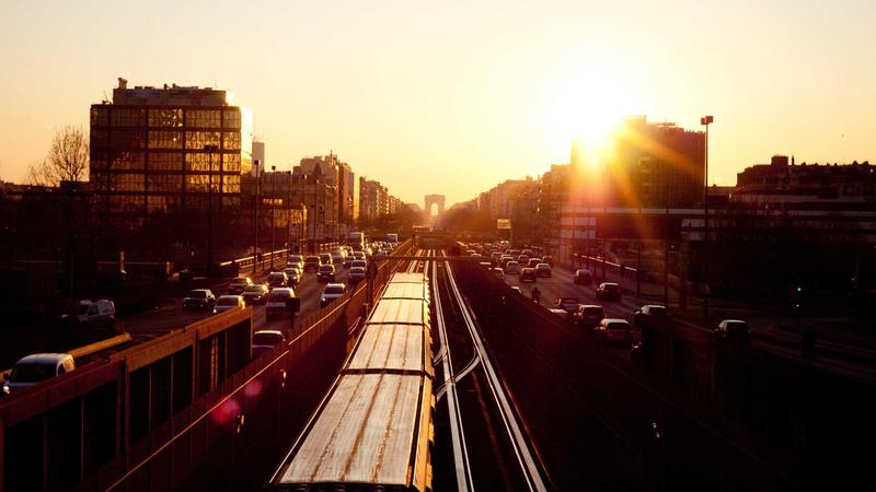 A detailed macro shot of a wireless earbud showing the silicone tip and charging contacts, resting next to a modern charging case.