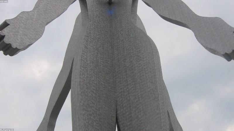 Close up of a person gently cleaning the silicone tips of a black wireless earbud using a microfiber cloth and a soft brush.