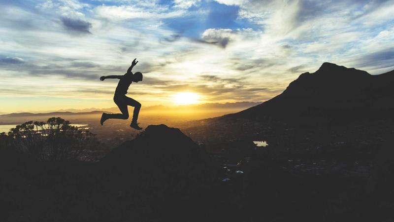 A futuristic rural Indian scene showing a farmer using a tablet to control an automated agricultural drone over a green field.