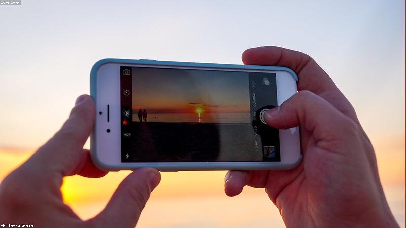 person holding iphone with chatgpt interface on screen