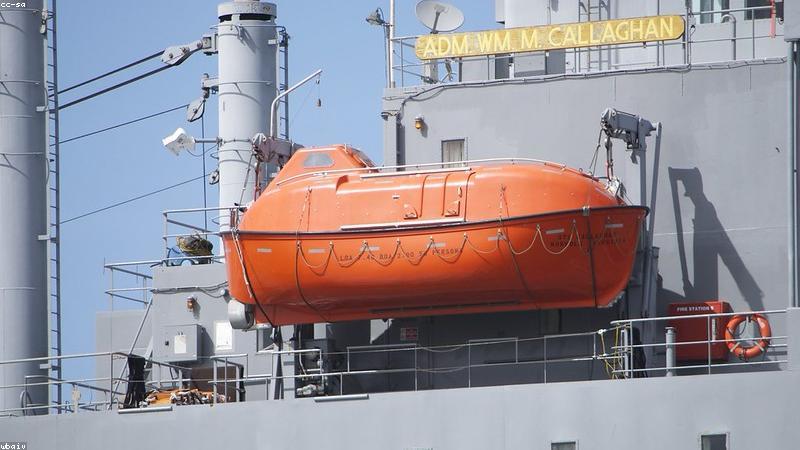 person working on a laptop at a cafe with a high-capacity power bank charging it
