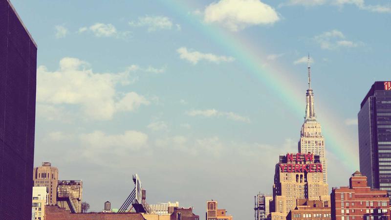 A split-screen visual showing a rugged Garmin watch with topographical maps on the screen on the left, and a sleek, minimalist Fitbit watch displaying stress management scores on the right.