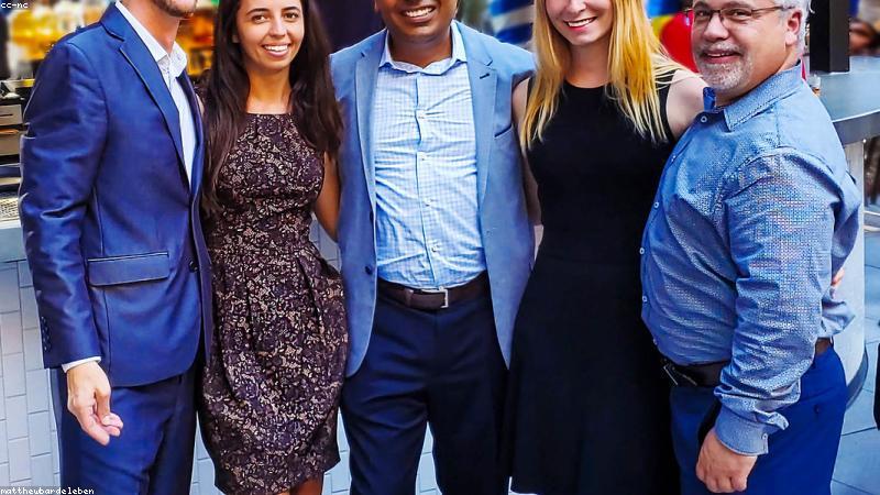 diverse young professionals looking at their smartwatches in a modern Indian office setting