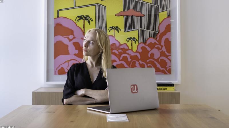 Startup employee working remotely in a well-lit home office with a modern ergonomic setup