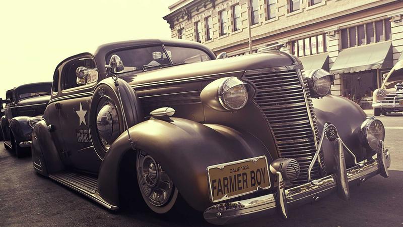 A glowing digital clock showing 9 PM next to a notepad with 'business plan' written on it, representing late-night time management.