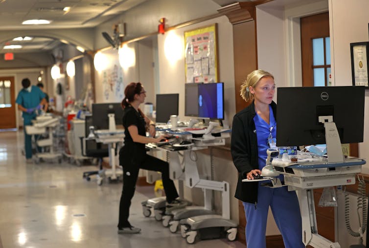 exhausted nurse charting at station 2026